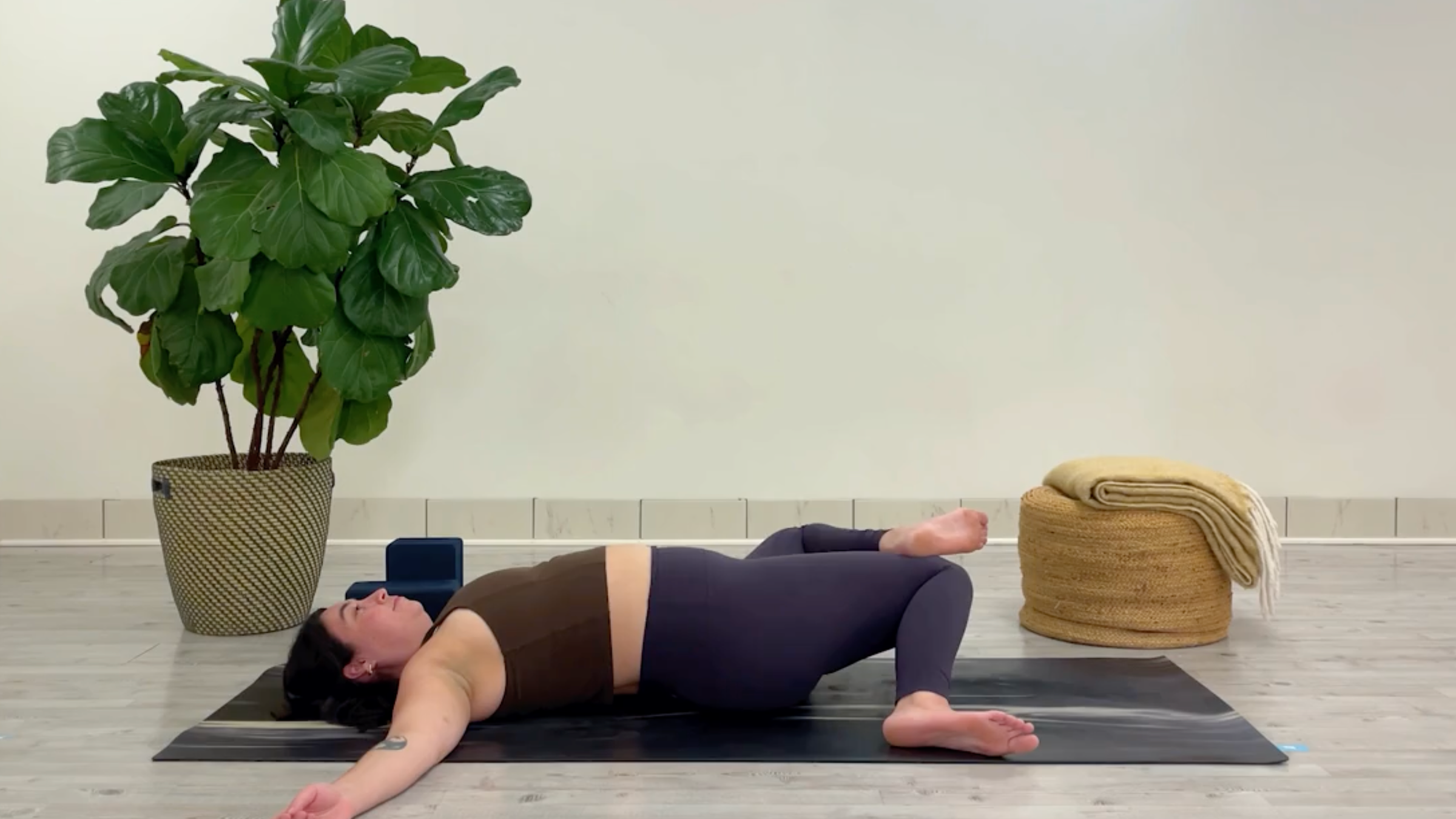 Yoga teacher Taylor Lorenz in Windshield Wipers, one of the best yoga poses for chilling out